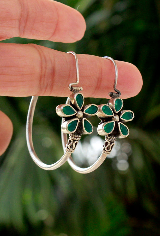 Silver hoop earrings with green floral designs