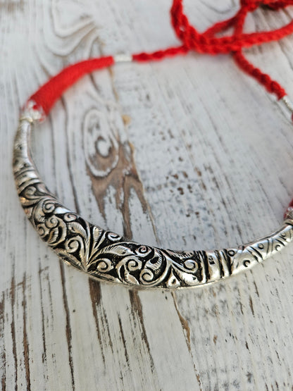 Handmade 925 oxidized sterling silver hasli necklace with chitai engraving and adjustable red cotton thread, on white wood