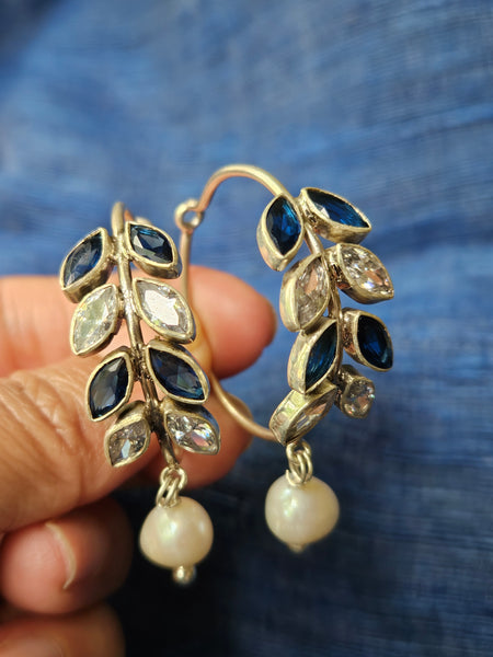 925 Sterling Silver Hoop with Cubic Zirconia Gemstones. Gemstones are designed in a leafy vine form. They add sparkle to this beautiful hoop earring. In addition there is a drop pearl which  adds movement and grace. Made by artisans by hand in Jaipur,India in pure sterling silver. #silverisforever #kevasilver #kevadesign