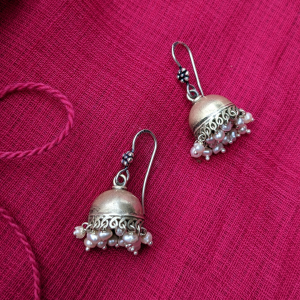 This is a small 925 Sterling Silver Jhumka with pearl drops. Lightweight and very easy to wear with the wire hook. It is made in pure silver by expert craftsmen of Jaipur, India. It is a traditional Indian bell shaped ethnic earring which goes well all Indian attires.