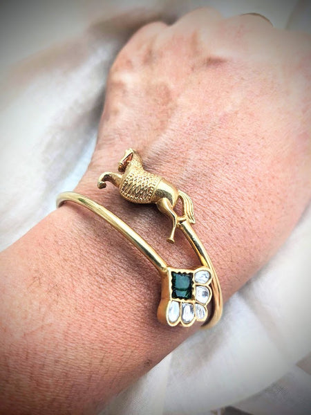 Contemporary pure silver with gold polish horse motif and green stone open bangle