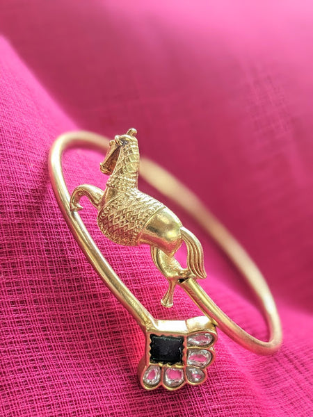 Contemporary pure silver with gold polish horse motif and green stone open bangle