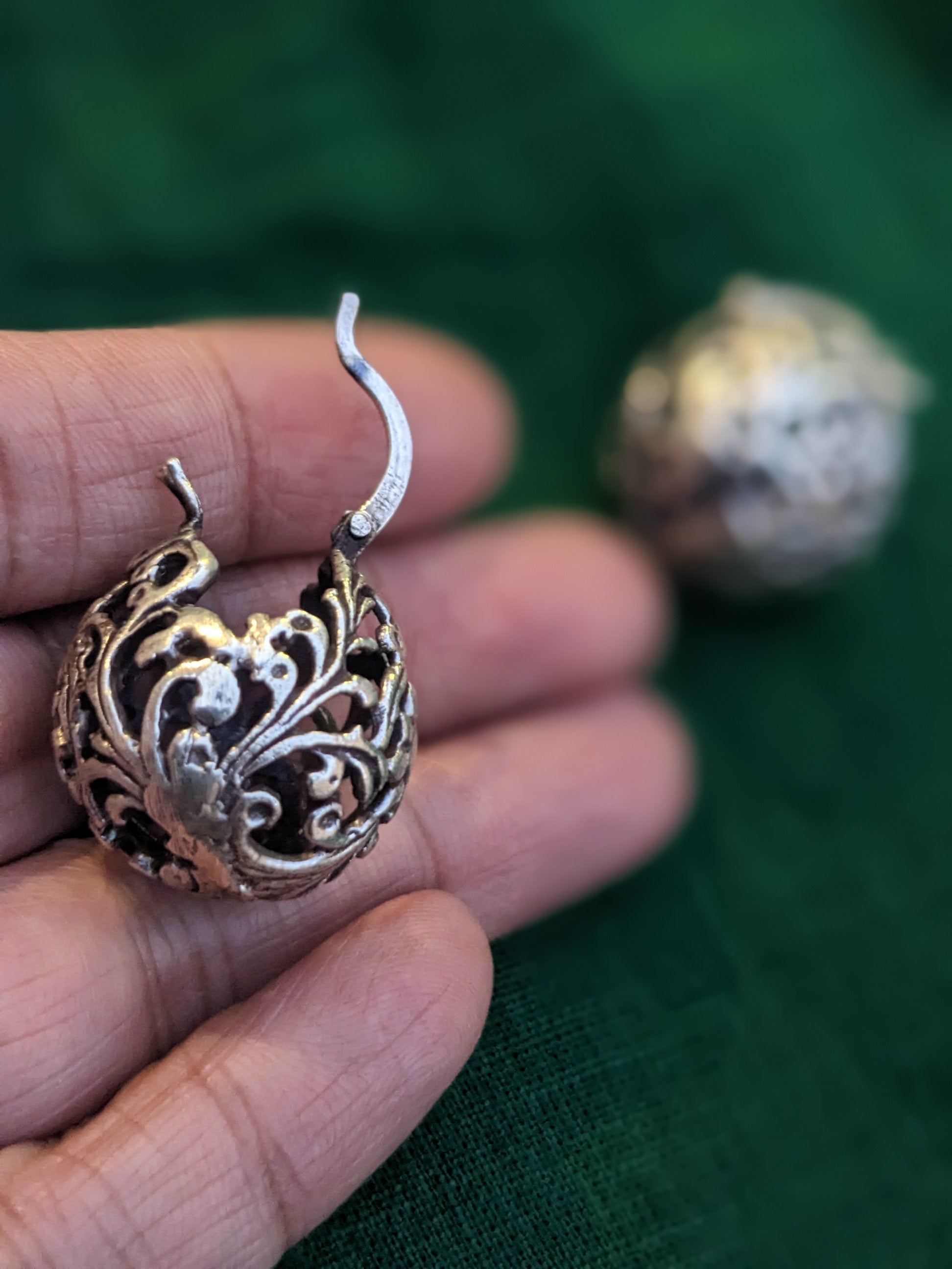 925 Sterling silver ball hoop earrings with a delicate floral design. The earrings are made of a filigree pattern and have oxidised finish.