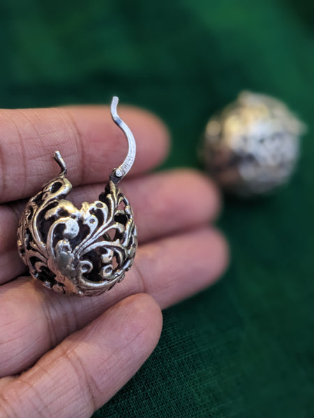 925 Sterling silver ball hoop earrings with a delicate floral design. The earrings are made of a filigree pattern and have oxidised finish.