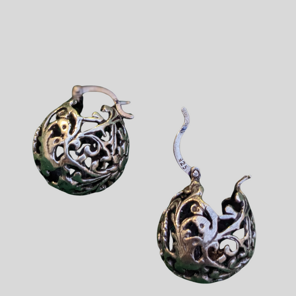 925 Sterling silver ball hoop earrings with a delicate floral design. The earrings are made of a filigree pattern and have oxidised finish.