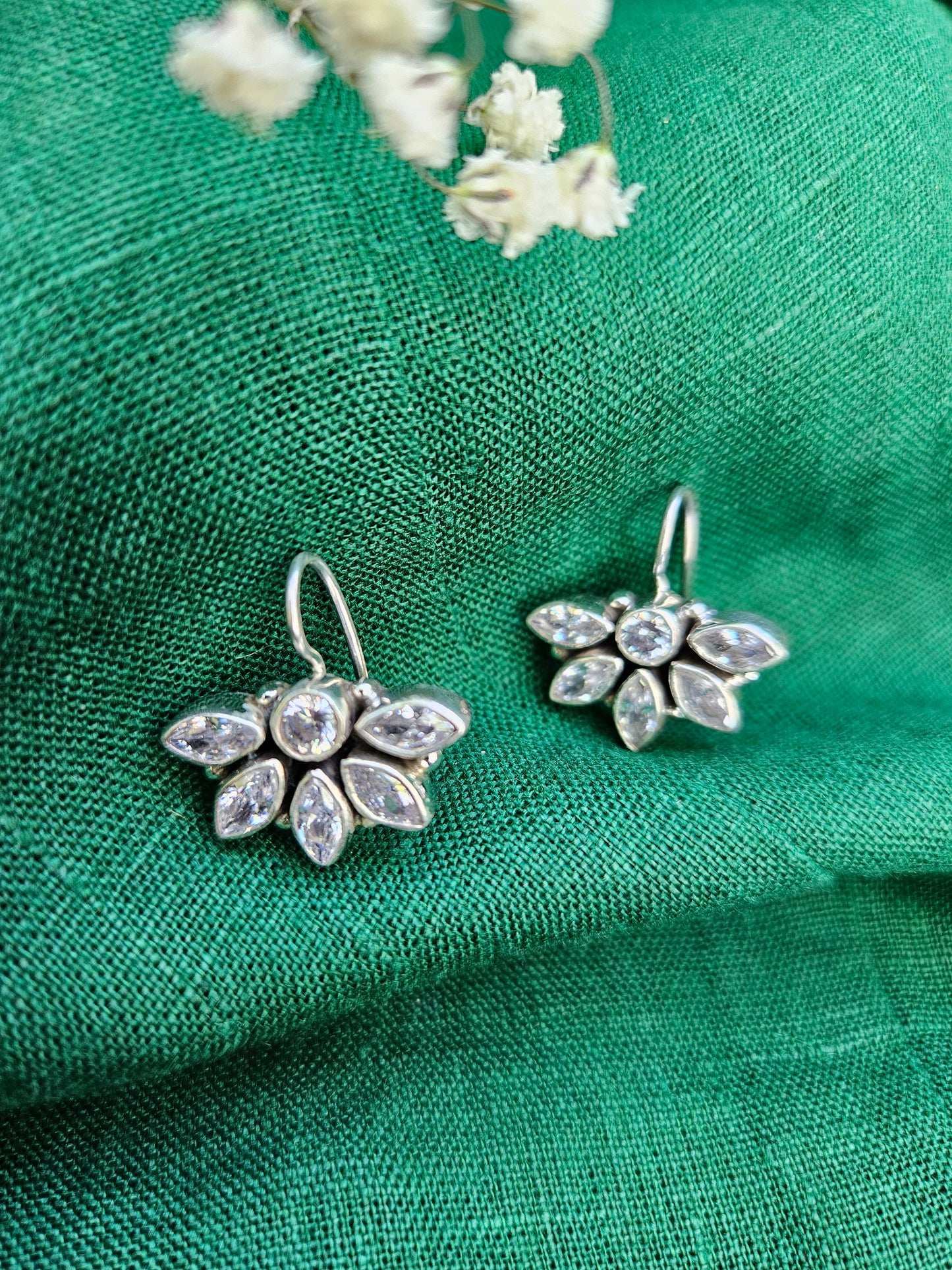 this is a pair of handcrafted 925 sterling silver hook earring in floral petal pattern. Lightweight, easy to wear made in pure silver this silver earring is forever classic. It has indian ethnic feel yet versatile. It makes for a thoughtful silver jewelry gift for women on any occasion. 