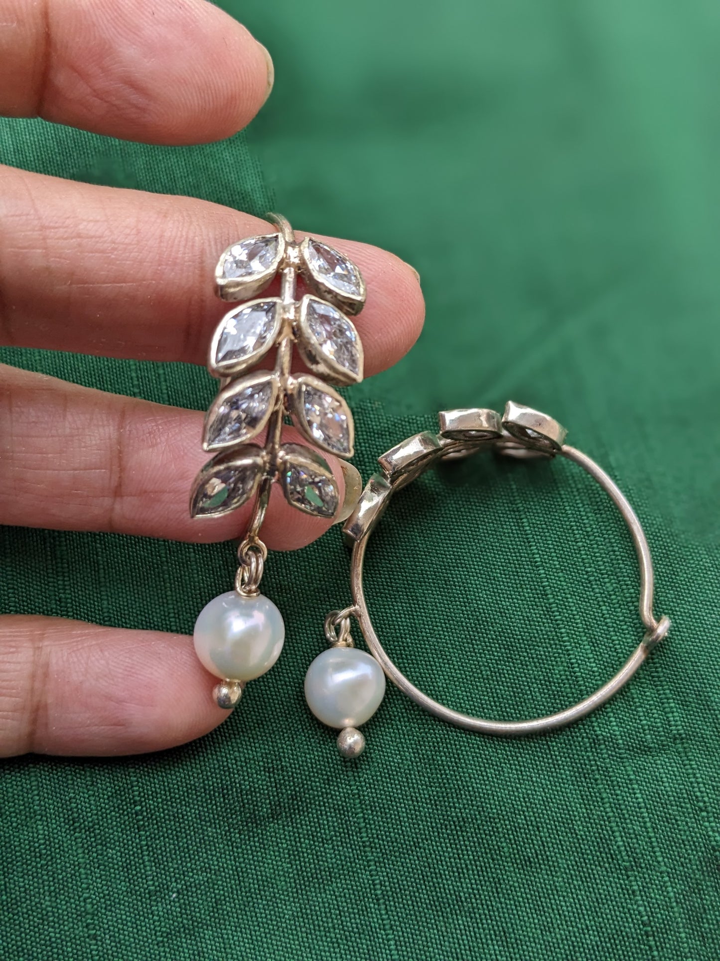 925 Sterling Silver Hoop with Cubic Zirconia Gemstones. Gemstones are designed in a leafy vine form. They add sparkle to this beautiful hoop earring. In addition there is a drop pearl which  adds movement and grace. Made by artisans by hand in Jaipur,India in pure sterling silver. #silverisforever #kevasilver #kevadesign