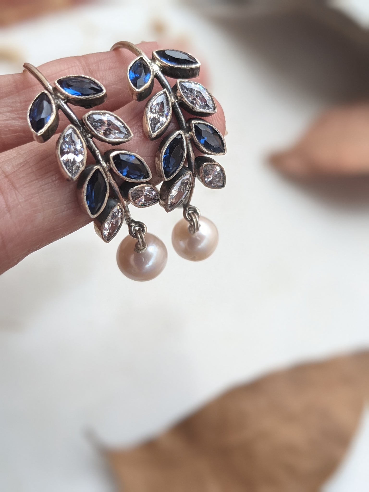 925 Sterling Silver Hoop with Cubic Zirconia Gemstones. Gemstones are designed in a leafy vine form. They add sparkle to this beautiful hoop earring. In addition there is a drop pearl which  adds movement and grace. Made by artisans by hand in Jaipur,India in pure sterling silver. #silverisforever #kevasilver #kevadesign