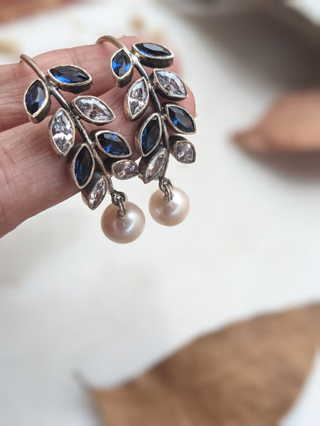 925 Sterling Silver Hoop with Cubic Zirconia Gemstones. Gemstones are designed in a leafy vine form. They add sparkle to this beautiful hoop earring. In addition there is a drop pearl which  adds movement and grace. Made by artisans by hand in Jaipur,India in pure sterling silver. #silverisforever #kevasilver #kevadesign