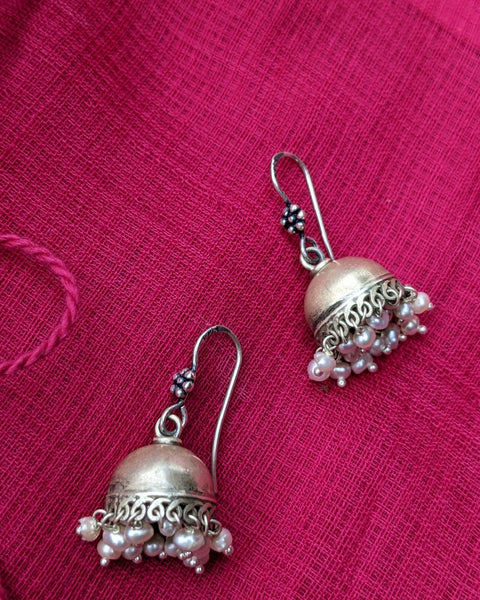 This is a small 925 Sterling Silver Jhumka with pearl drops. Lightweight and very easy to wear with the wire hook. It is made in pure silver by expert craftsmen of Jaipur, India. It is a traditional Indian bell shaped ethnic earring which goes well all Indian attires.